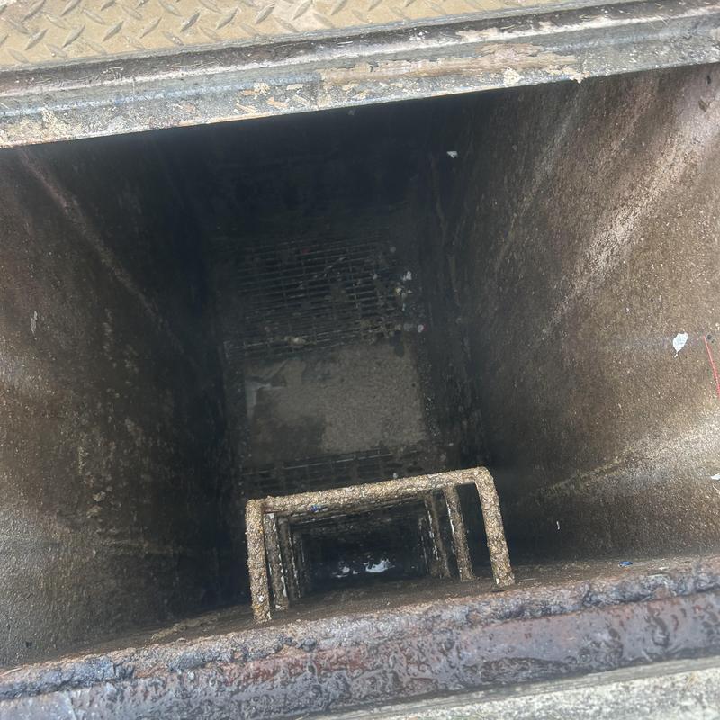 Sanitary line manhole interior with metal ladder