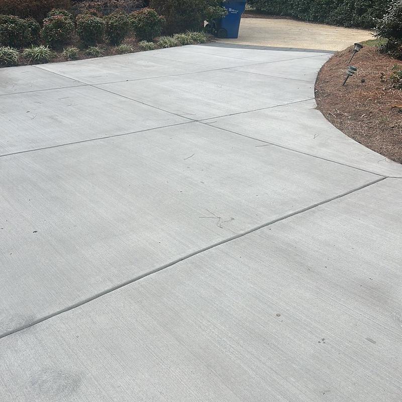 Concrete driveway with expansion joints and landscaping edge