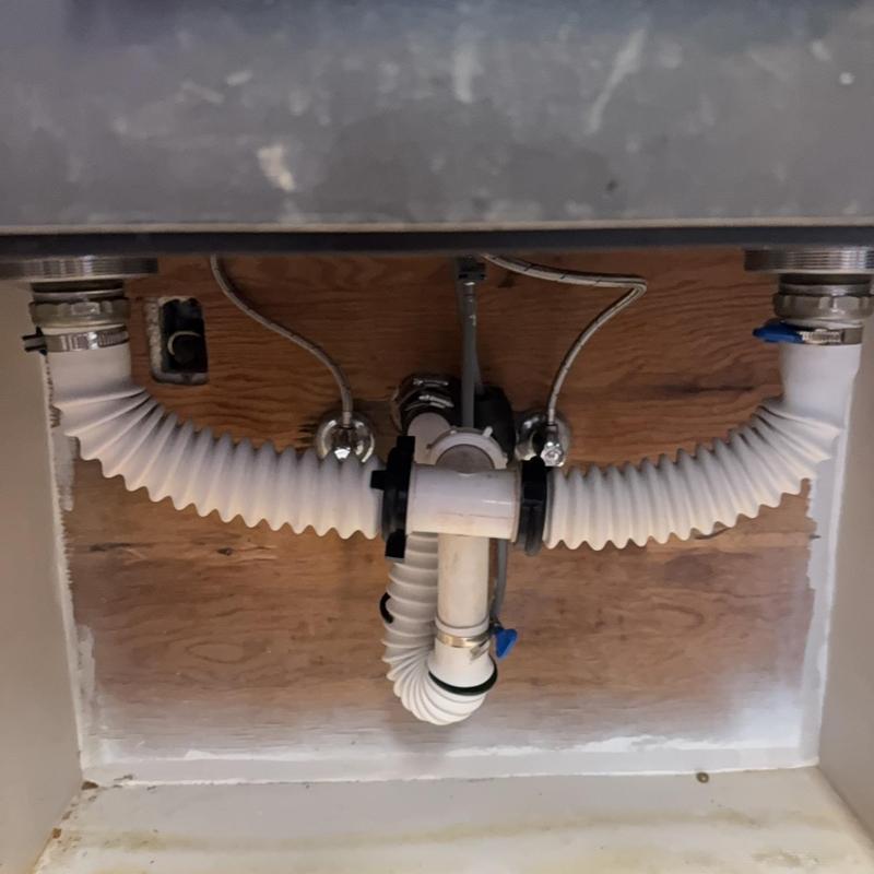 Sink drain pipes and flexible tubing installation under cabinet