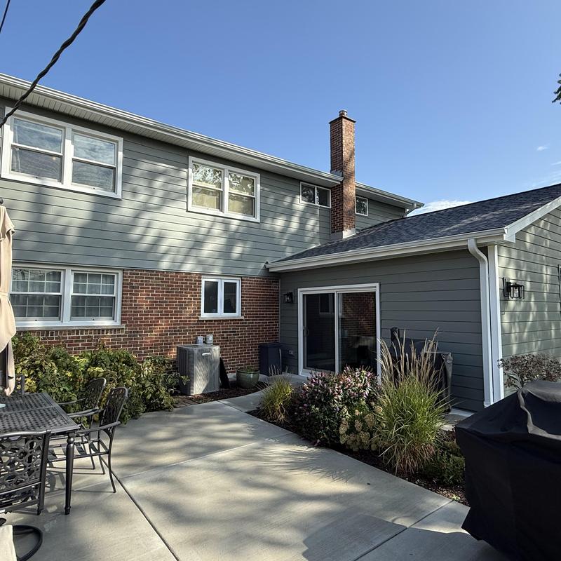 Composite insulated siding and gutters on house exterior