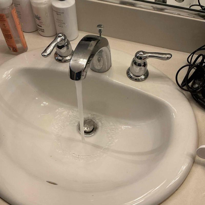 Bathroom sink faucet with water running