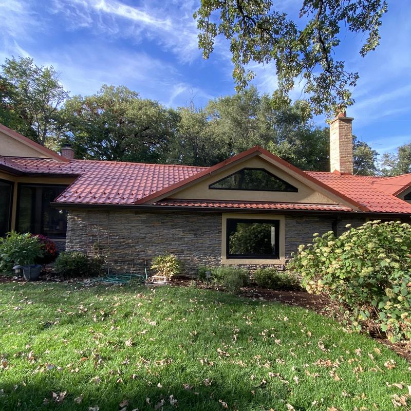 Metal roof installation on residential home exterior