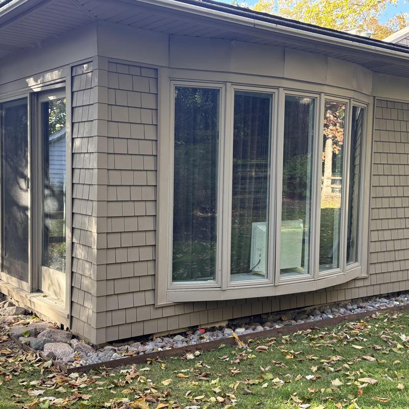 Vinyl shake siding on house corner with windows