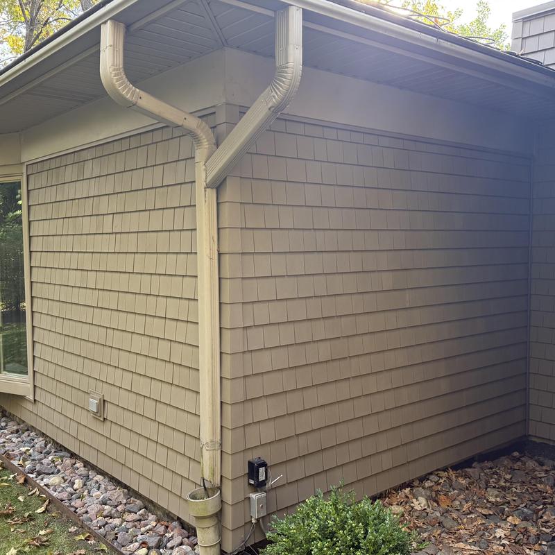 Vinyl shake siding with gutter downspouts in Deerfield