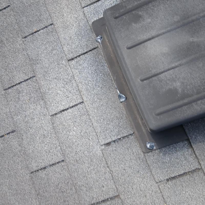 Pipe boot on asphalt shingle roof with caulked sealant
