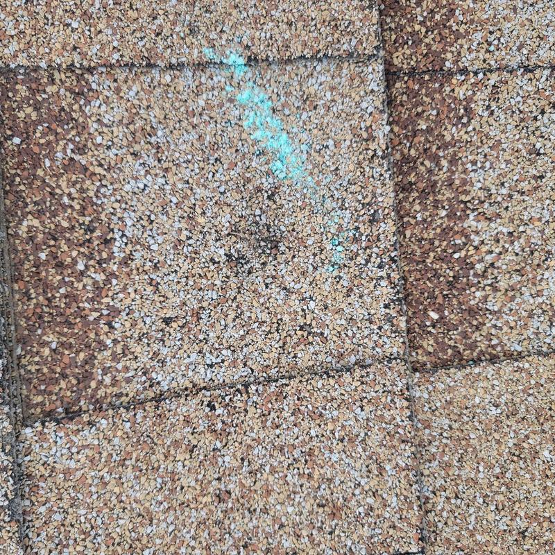 Asphalt shingle roof with hail damage markings Asphalt shingle roof with hail damage markings
