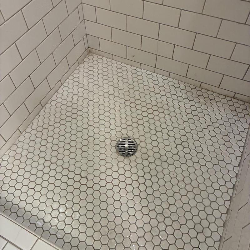 Shower drain with hex tile and metal grate cleaning