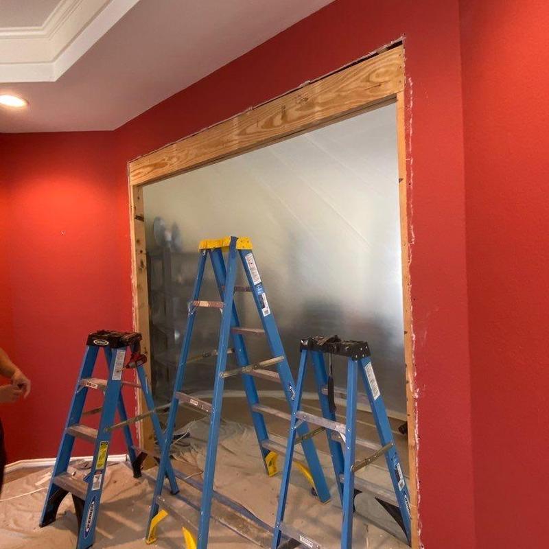 Arched wall opening framed between dining and family rooms