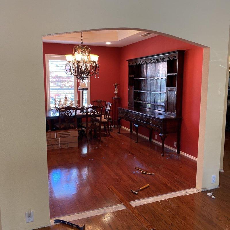 Arched wall opening and hardwood floor repair in dining room