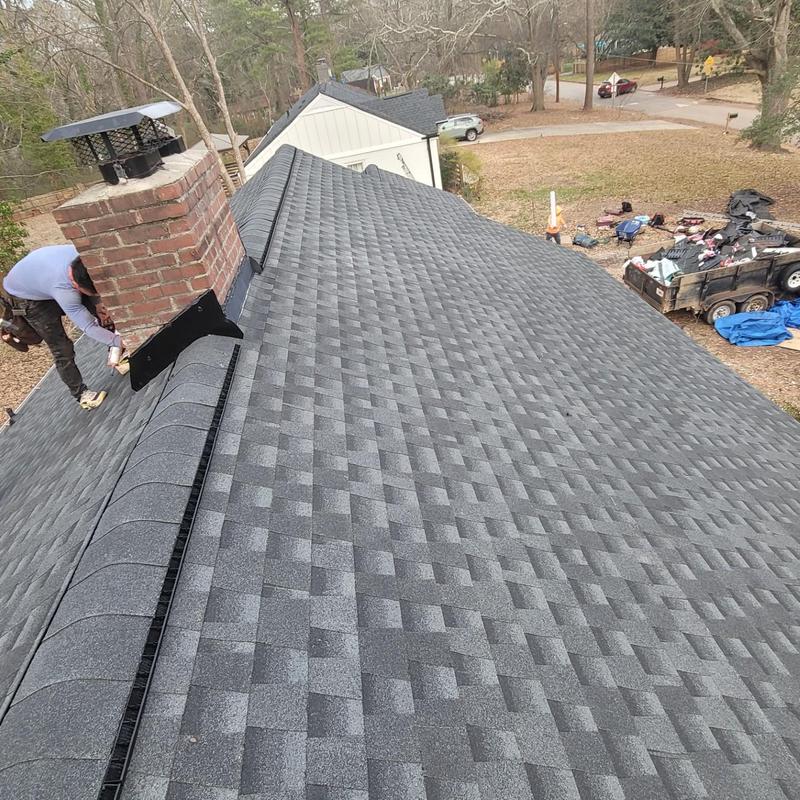 Asphalt shingle roof with chimney flashing installation