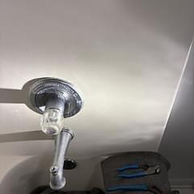 Pressure balanced tub shower valve with tools on floor