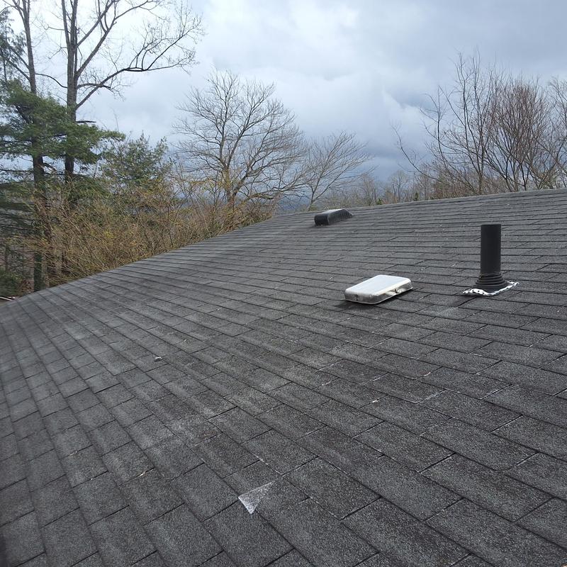 Shingle roof with wind damage and aging in Unicoi, TN