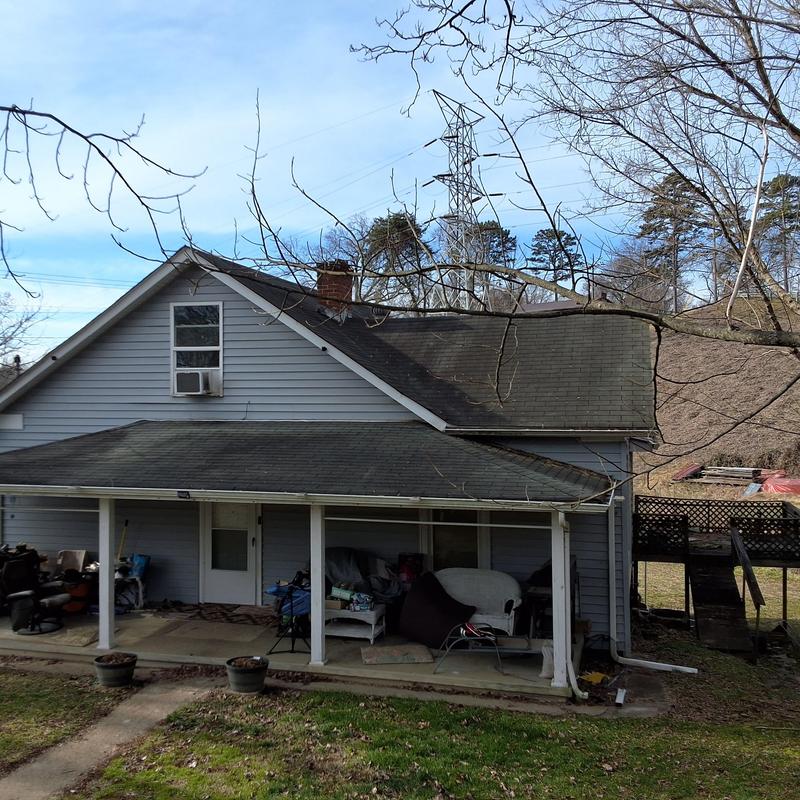 Asphalt shingle roof with porch and yard view