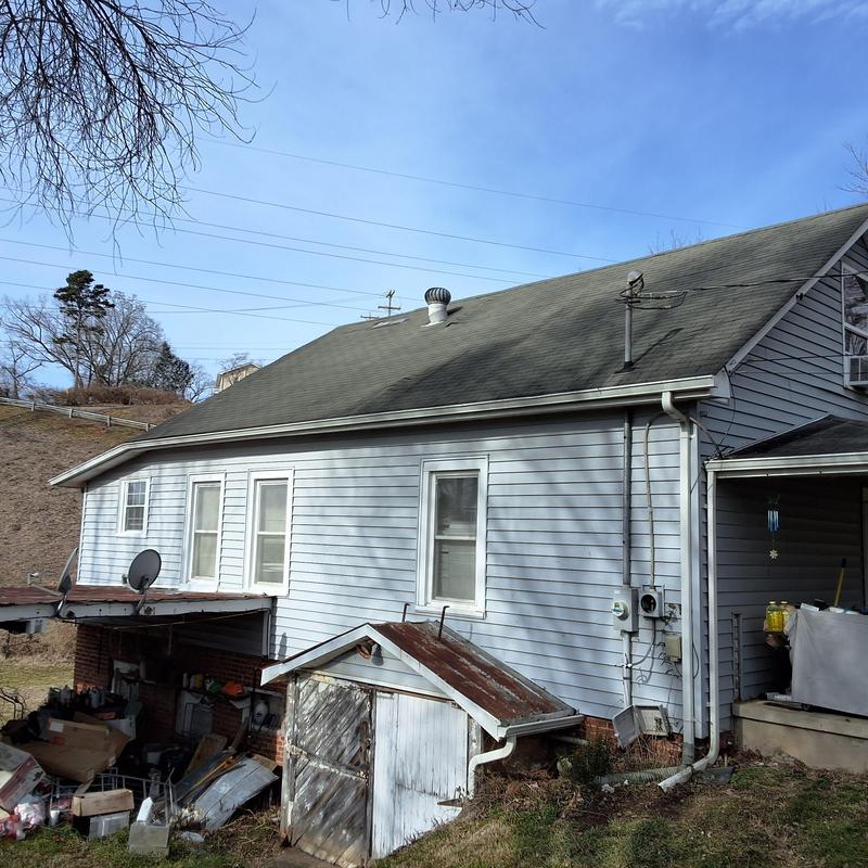 Asphalt shingle roof with gutters on residential house