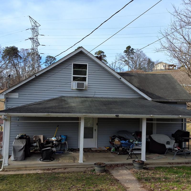 Asphalt shingle roof with porch and window AC unit