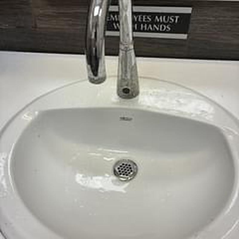 Lavatory sink drain with chrome faucet in restroom