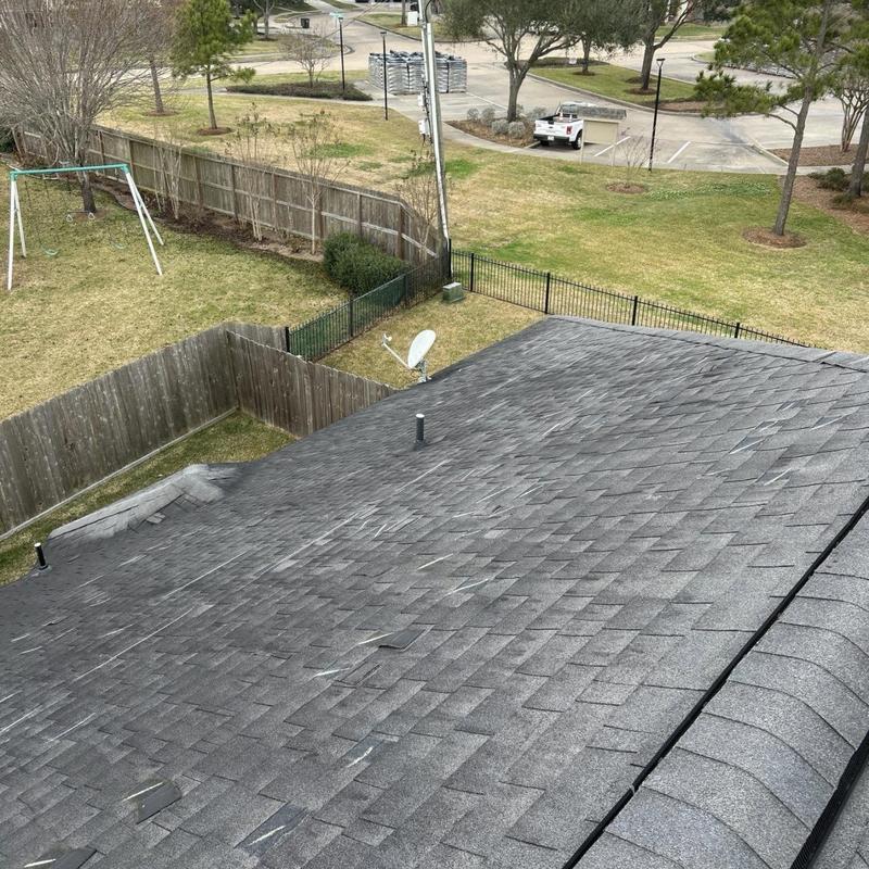 Asphalt shingle roof with wind damage inspection