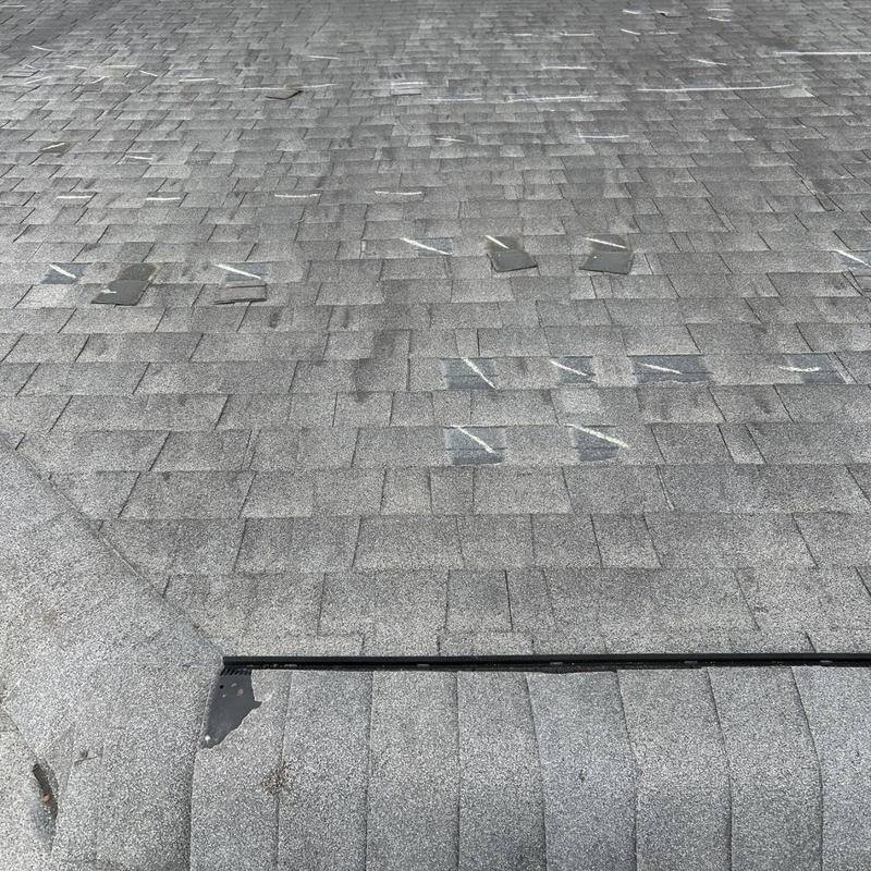 Asphalt shingle roof with wind damage markings