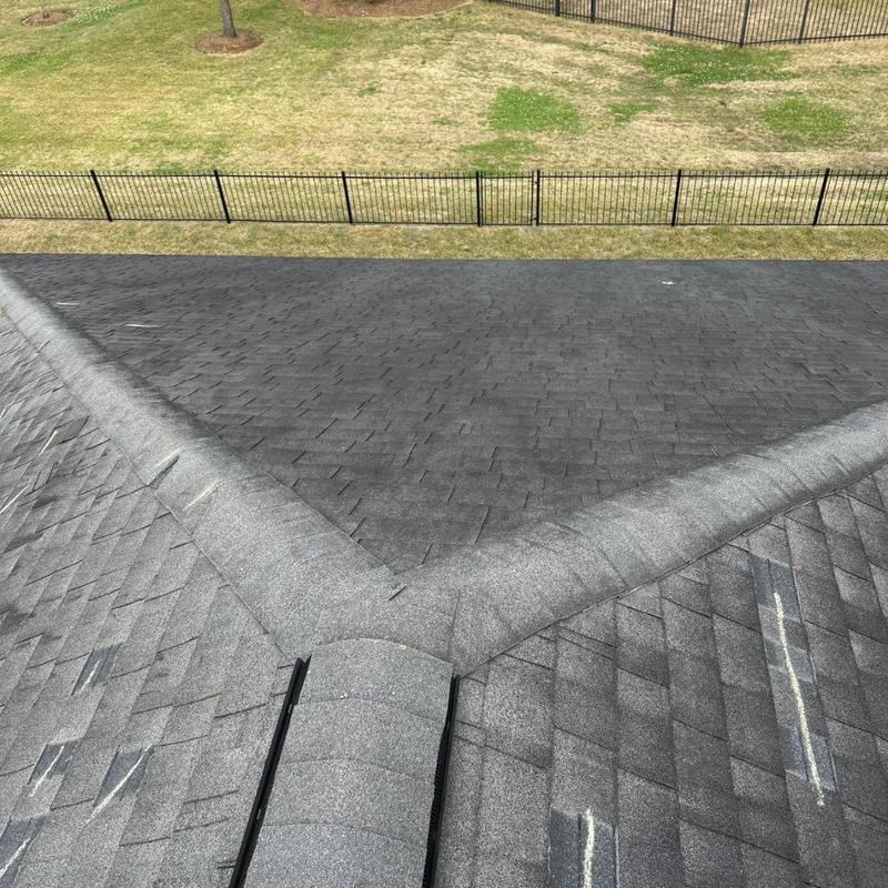 Roof shingles with wind damage and lifted tabs