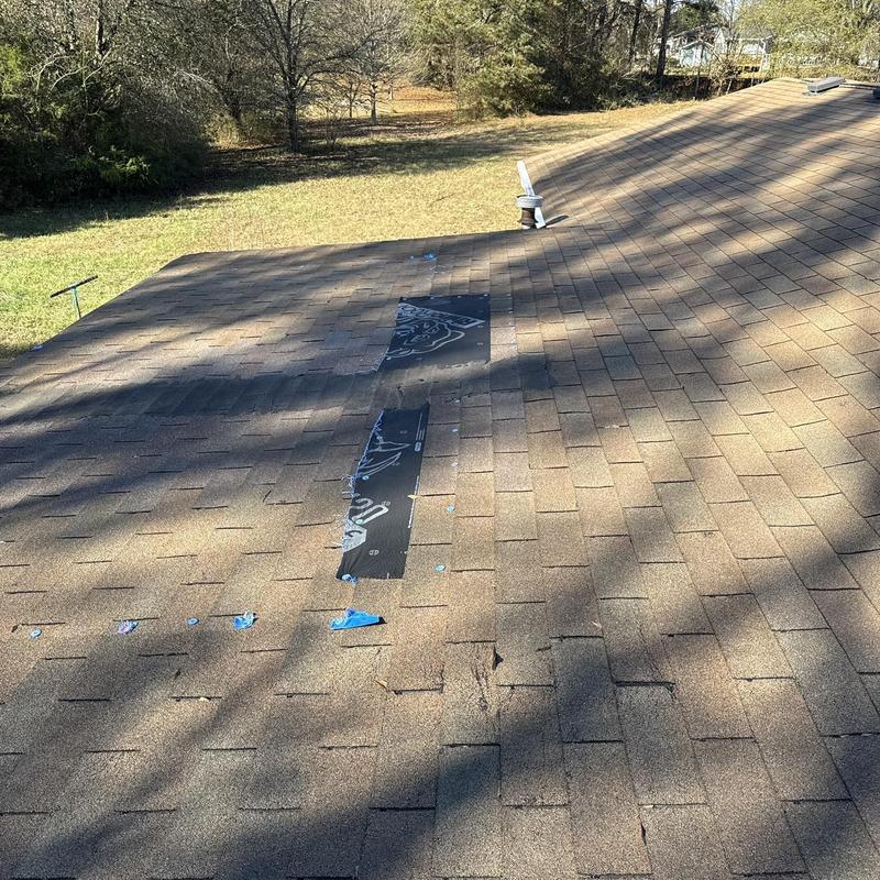 Back porch roof with new shingle strip installation