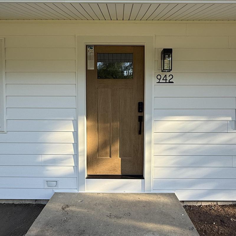 Composite insulated siding with front door and light