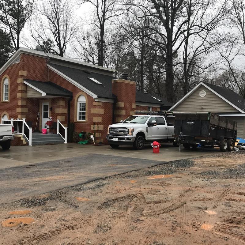 Concrete driveway with work trucks and remodeling equipment Concrete driveway with work trucks and remodeling equipment