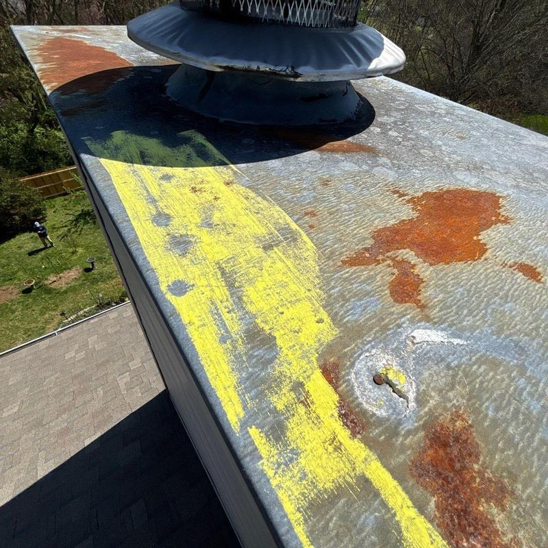 Chimney cap roof flashing with rust and markings