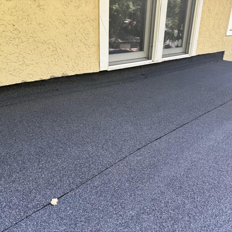 Flat roof with new protective membrane near window