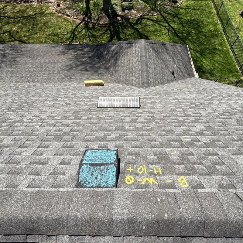 Roof shingles with hail damage marks and roof vents