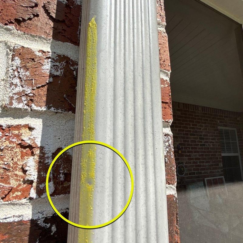 Vinyl column with hail impact marked in yellow paint