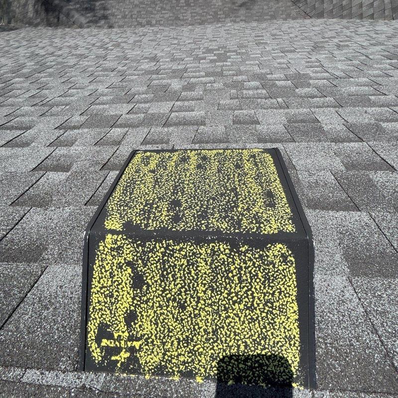 Roof vent with hail damage on asphalt shingles