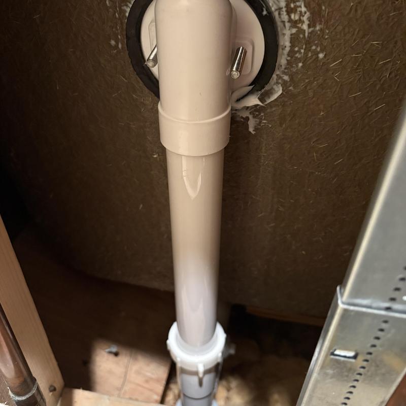 PVC tub waste and overflow pipe installation in wall cavity