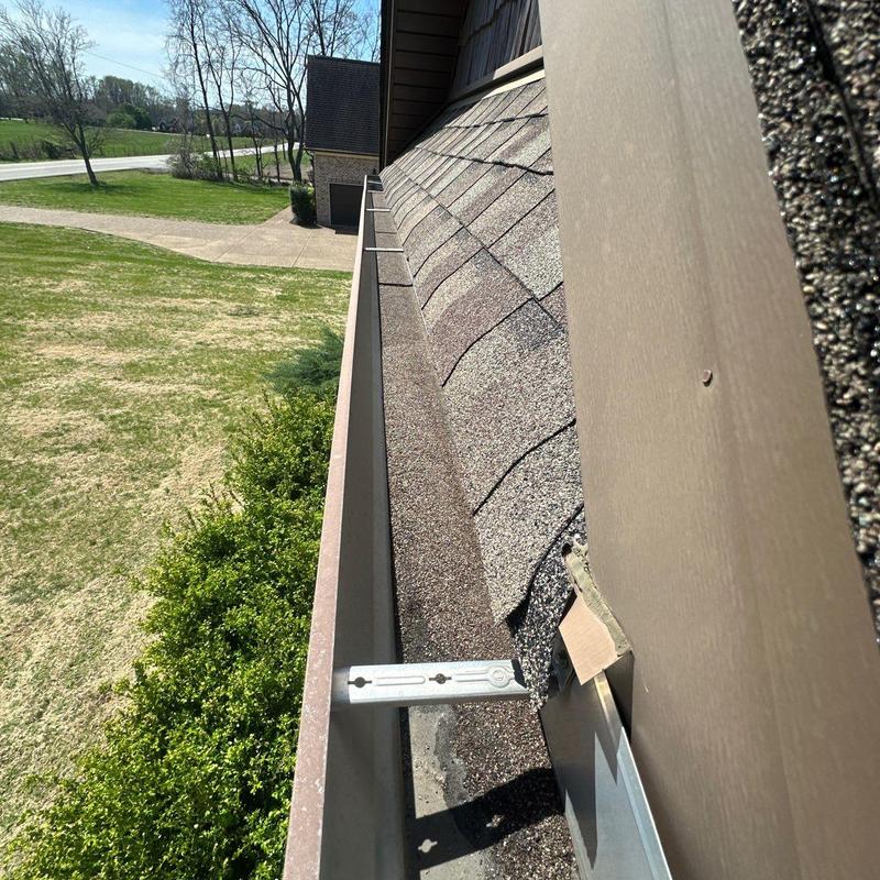 Roof shingles with hail damage near gutter system