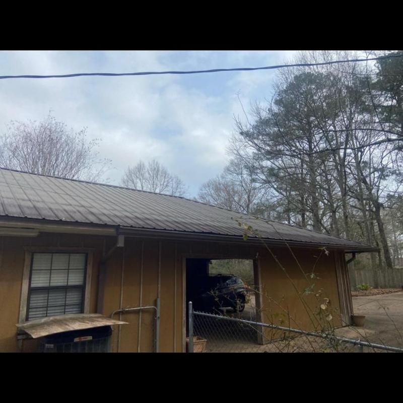 Metal roof system inspection on residential garage roof