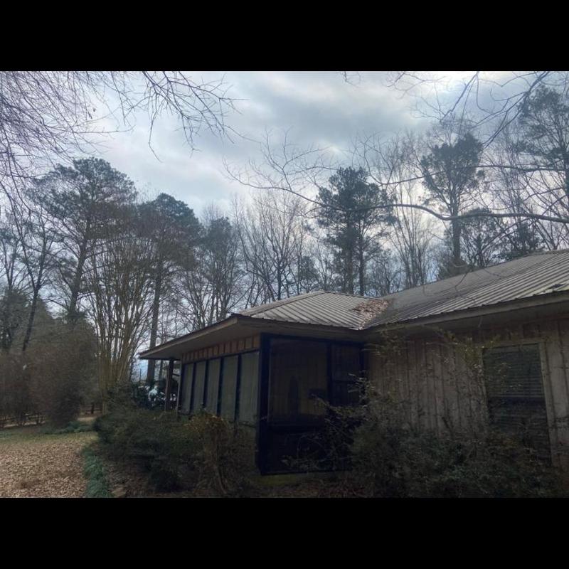Metal roof system with damaged ridge and debris
