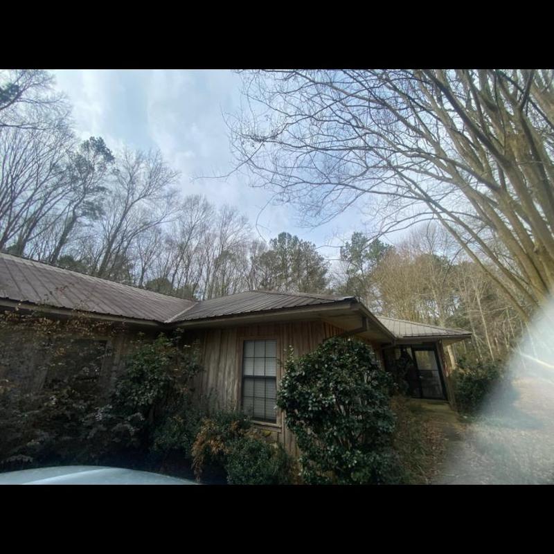 Metal roof inspection on residential home exterior