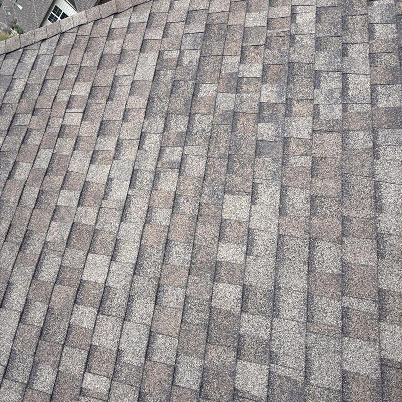 Asphalt shingle roof with hail damage and wear