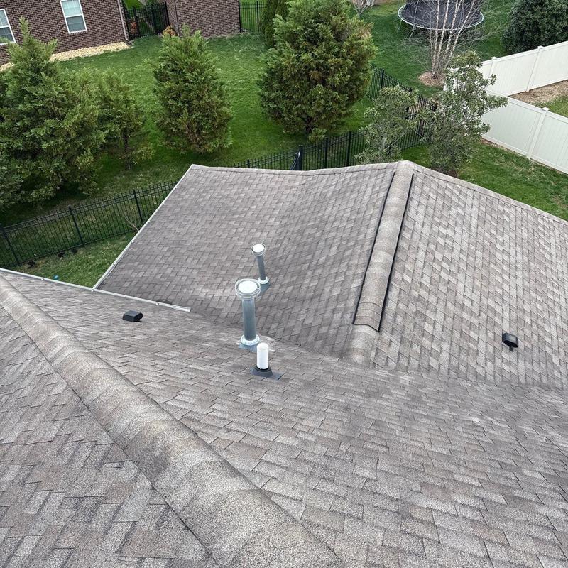 Asphalt shingle roof with ventilation pipes and ridge components