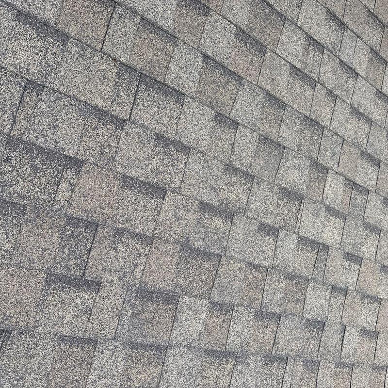 Asphalt shingle roof with hail damage inspection