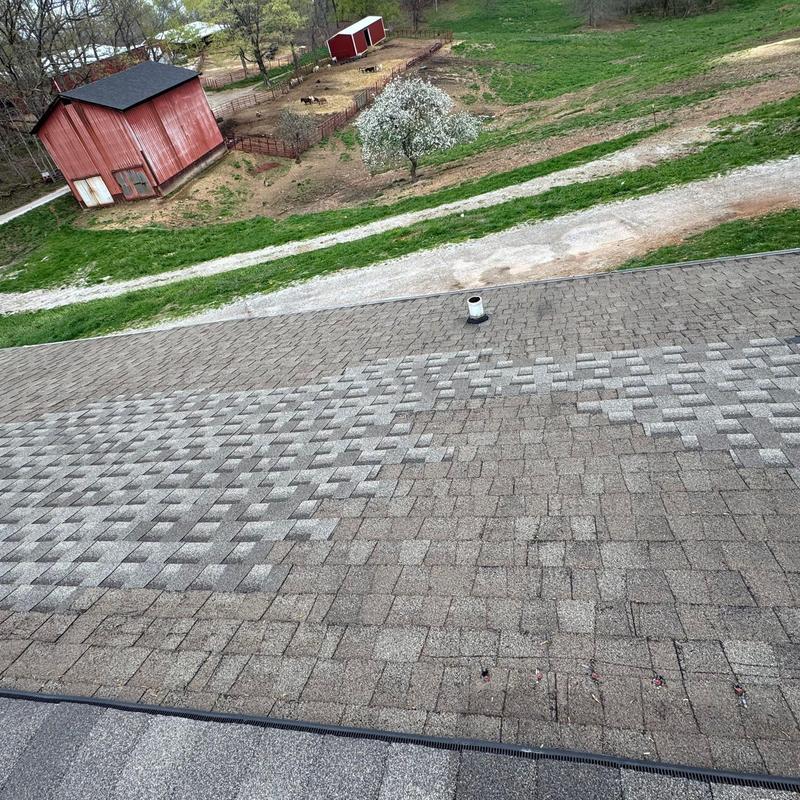 Asphalt shingle roof with hail damage inspection