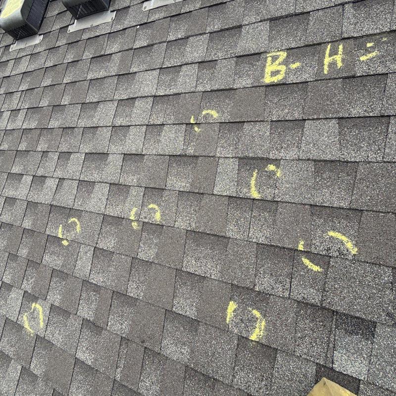 Roof shingles marked for hail damage inspection