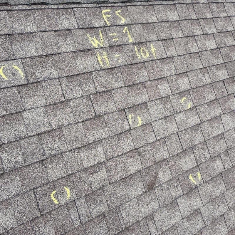 Asphalt shingles with marked hail damage spots