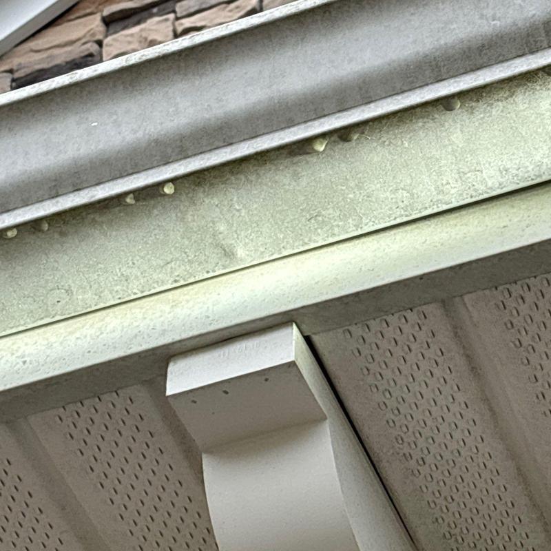 Metal fascia with hail impact dents and weathering