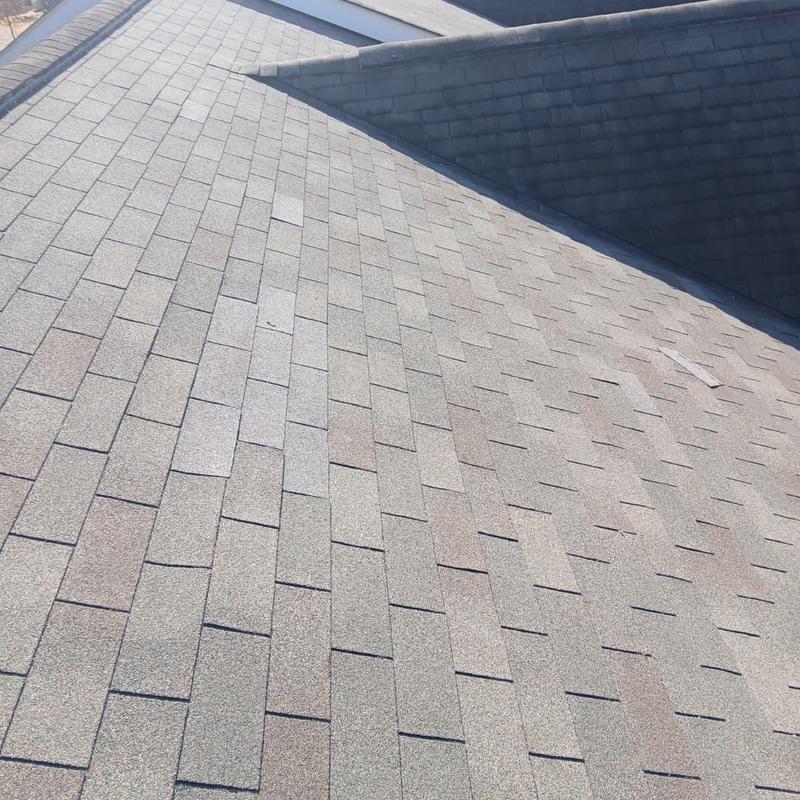 Asphalt shingle roof with replaced missing shingles
