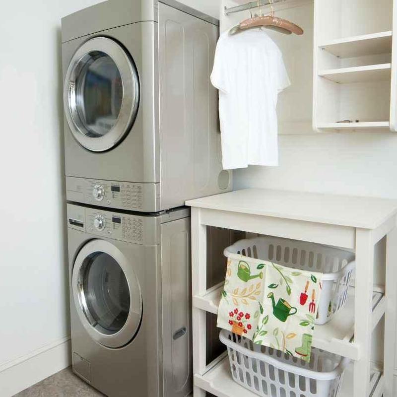 Front-load washer and dryer stacked in laundry room