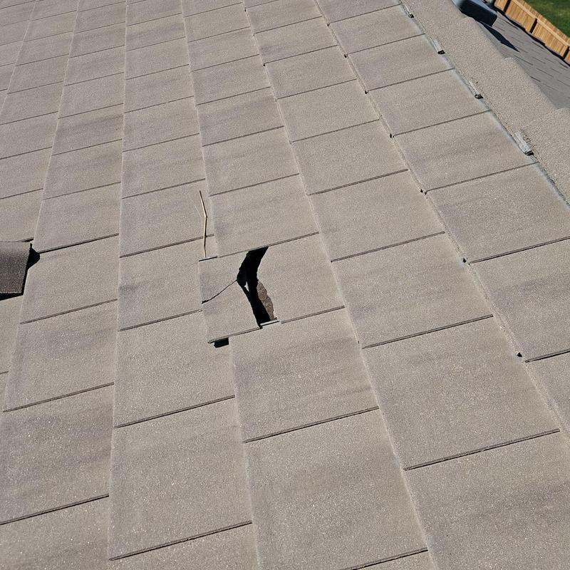 Broken tile on beige concrete roof tiles Broken tile on beige concrete roof tiles