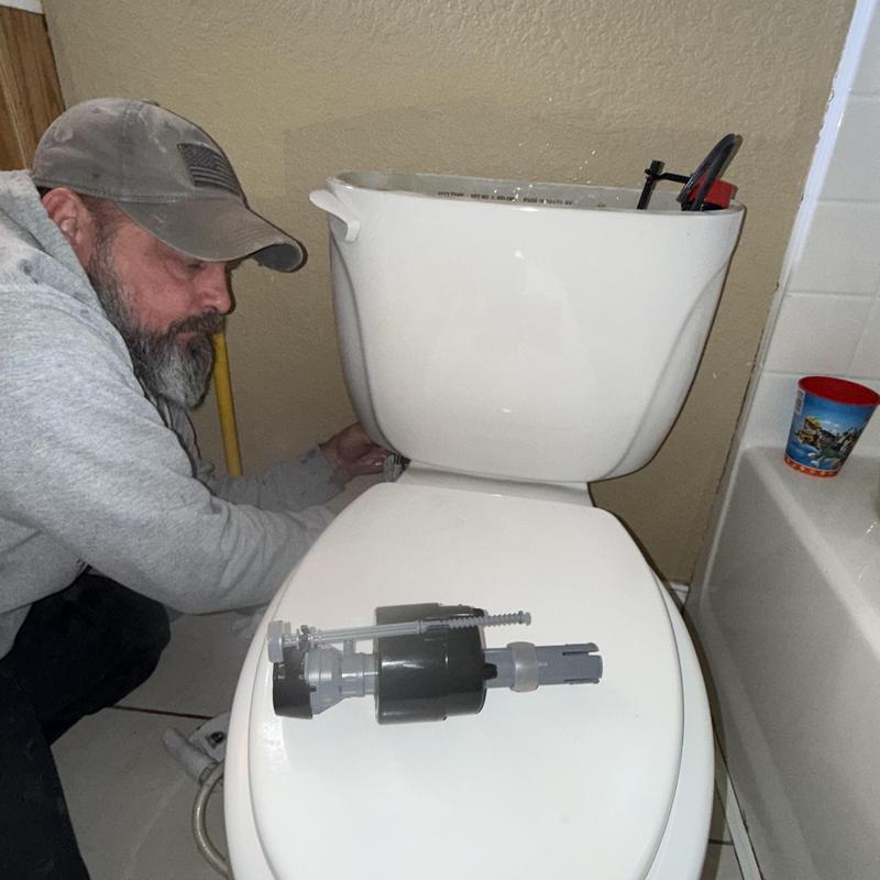 Toilet fill valve replacement in progress