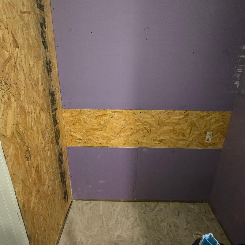 Custom shower wall with plywood backing and insulation