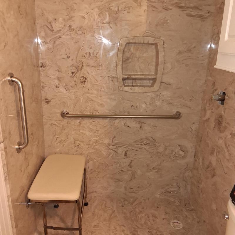 Groutless ADA-compliant shower with seat and grab bars