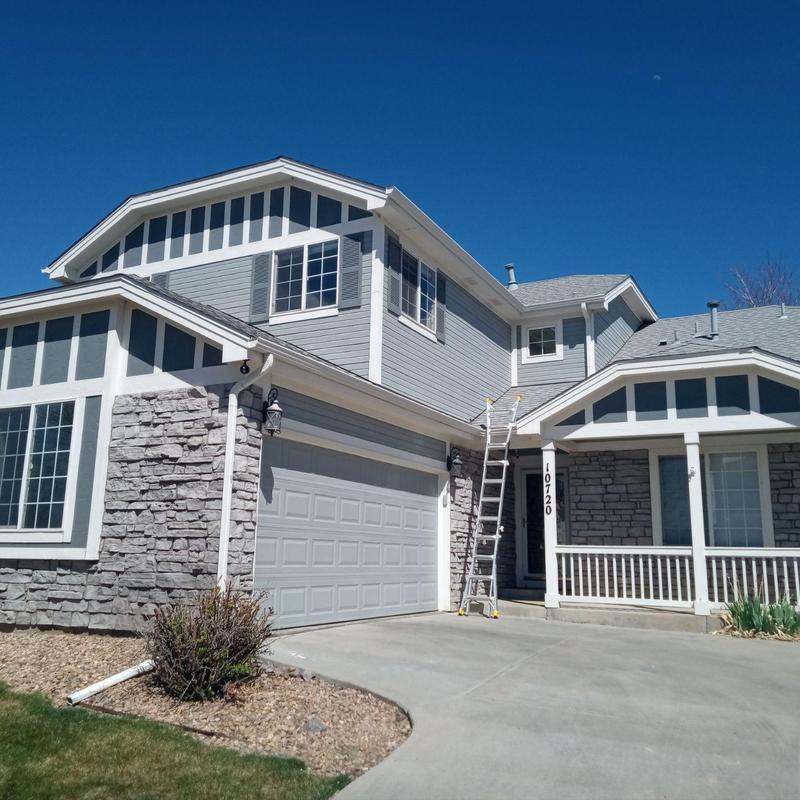 Shingle roof and ladder at residential home exterior Shingle roof and ladder at residential home exterior